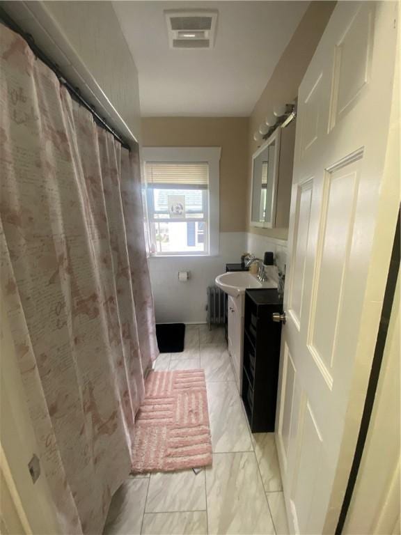 362 Webster Ave, Cranston, RI 02920 - bathroom with radiator, vanity, and a shower with shower curtain
