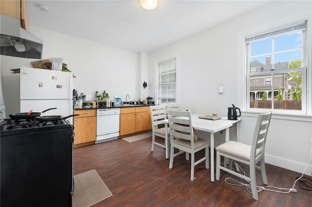 dining space with dark wood-type flooring and baseboards