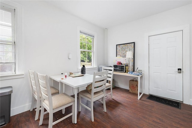 dining room featuring wood finished floors, an office area, and baseboards