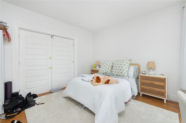 bedroom featuring wood finished floors and a closet