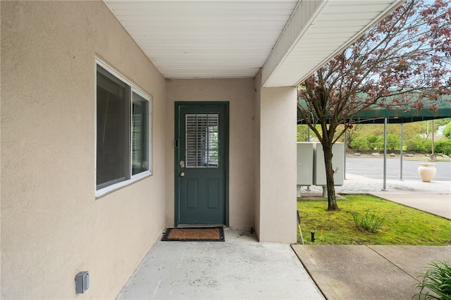 property entrance with stucco siding