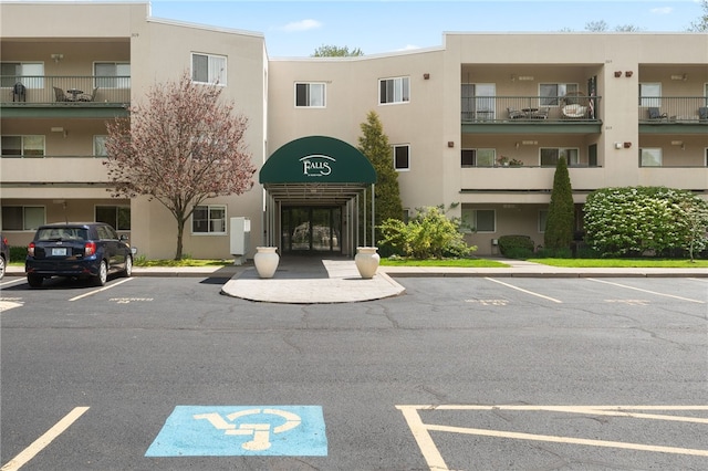view of property featuring uncovered parking