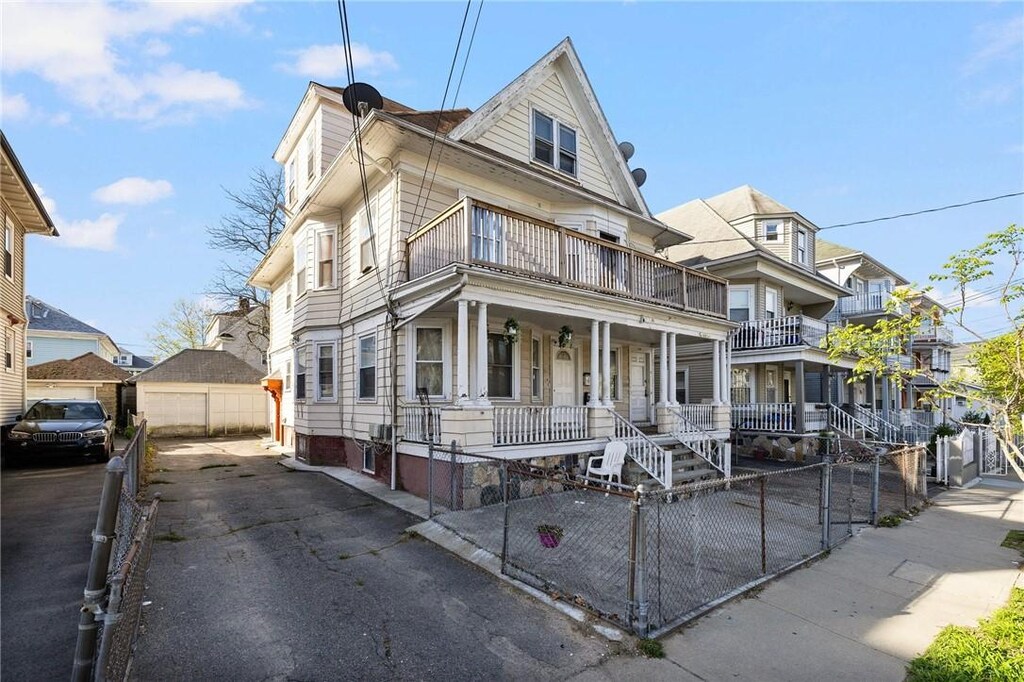 108 Lenox Ave, Providence, RI 02907 - view of front of home with a porch and a fenced front yard
