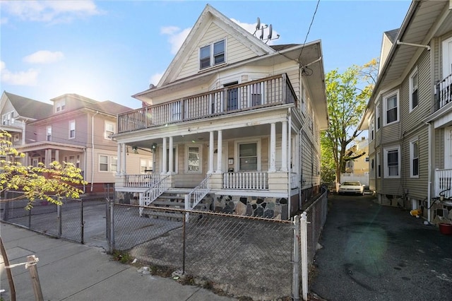 108 Lenox Ave, Providence, RI 02907 - view of front of home with a balcony, a porch, and a fenced front yard