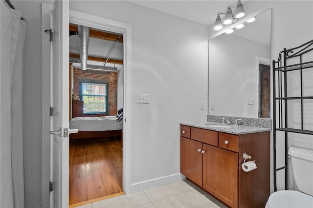 full bathroom featuring baseboards, toilet, connected bathroom, vanity, and tile patterned floors