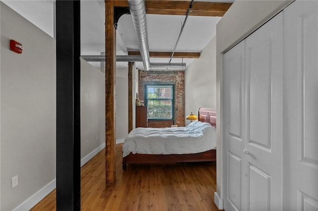 bedroom with baseboards and wood finished floors