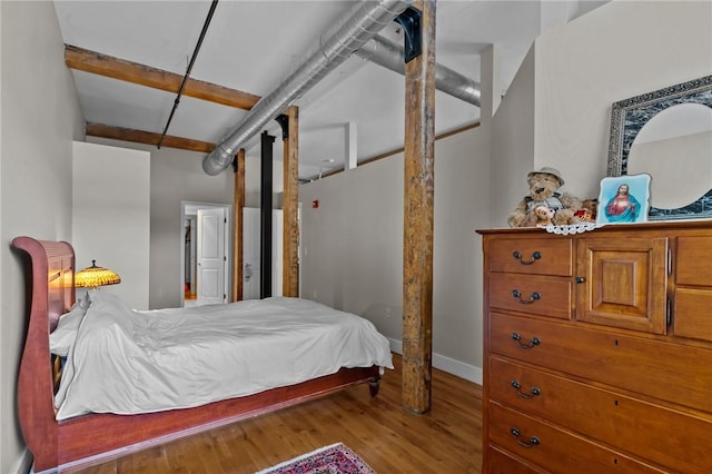 bedroom featuring wood finished floors and baseboards