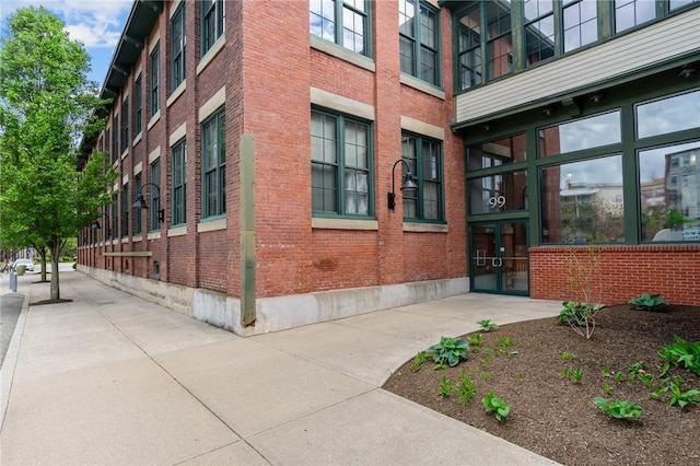 view of exterior entry with brick siding