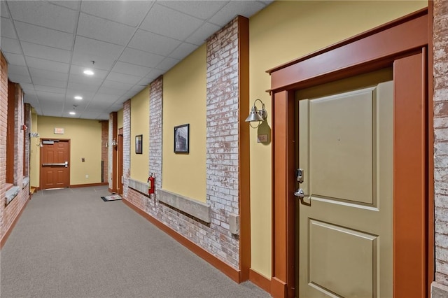 hall featuring carpet, a paneled ceiling, recessed lighting, and baseboards