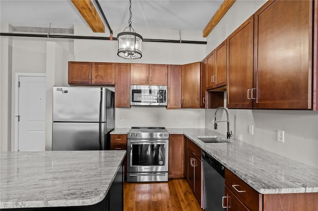 kitchen with appliances with stainless steel finishes, a sink, dark wood-type flooring, beam ceiling, and light stone counters