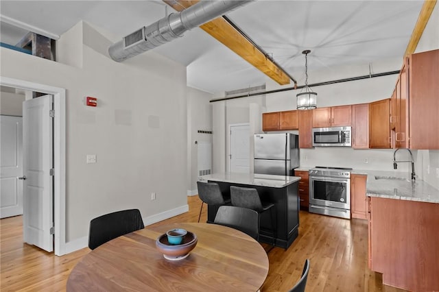 dining area with light wood-style flooring and baseboards
