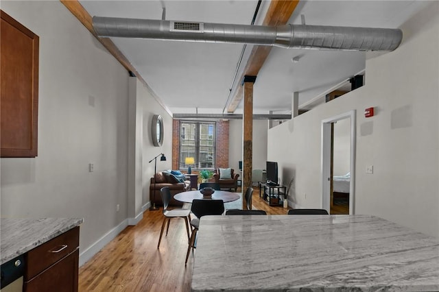 dining room with light wood-type flooring and baseboards
