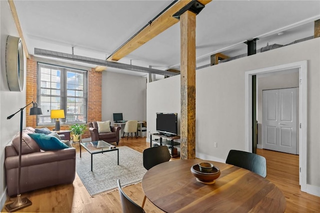living room with wood finished floors and beamed ceiling
