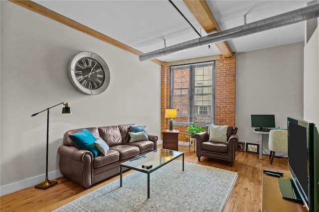 living room with beam ceiling, wood finished floors, and baseboards