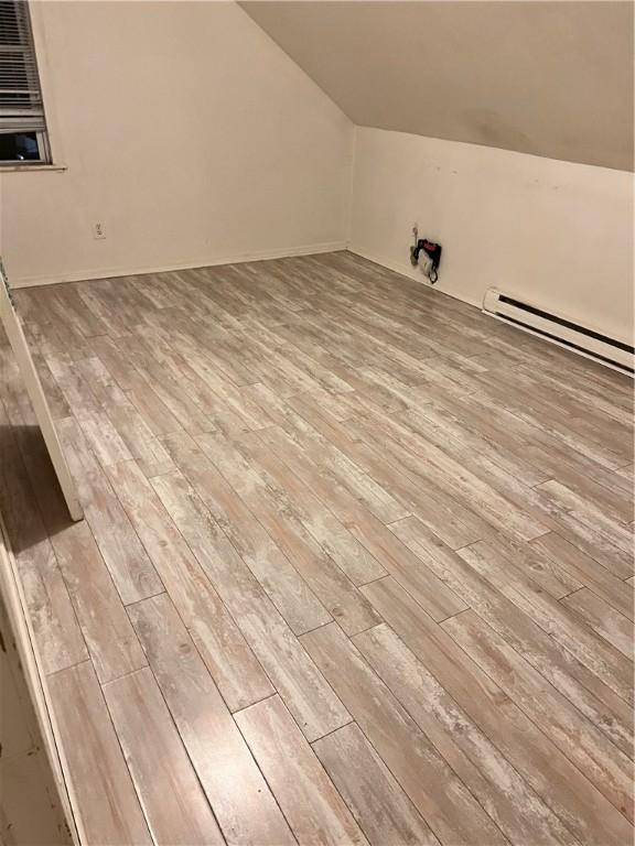 87 Oakland Ave, Providence, RI 02908 - additional living space with light wood-style floors, lofted ceiling, and baseboard heating