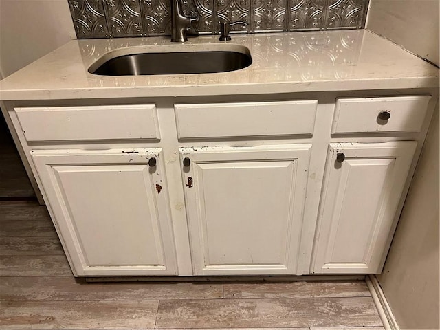 87 Oakland Ave, Providence, RI 02908 - kitchen view of a sink, wood finished floors, white cabinets, and light countertops