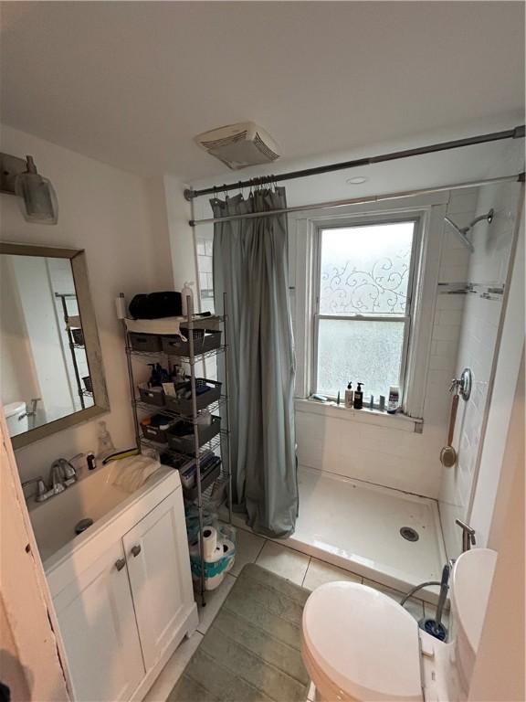 87 Oakland Ave, Providence, RI 02908 - full bathroom with a shower stall, vanity, and tile patterned flooring