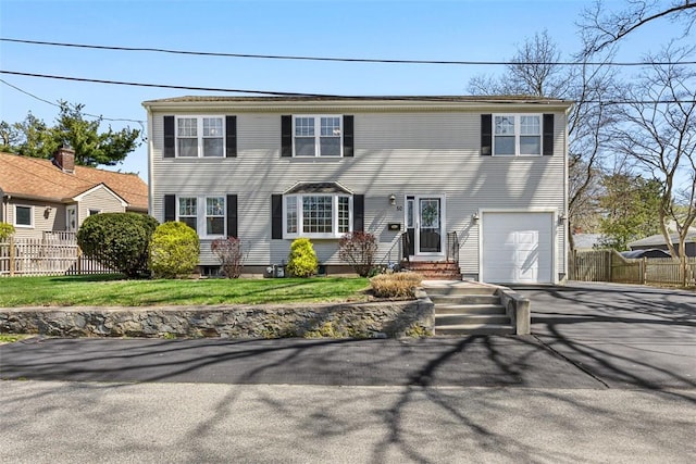 50 Harold St, East Providence, RI 02915 - colonial home featuring fence, asphalt driveway, an attached garage, and entry steps