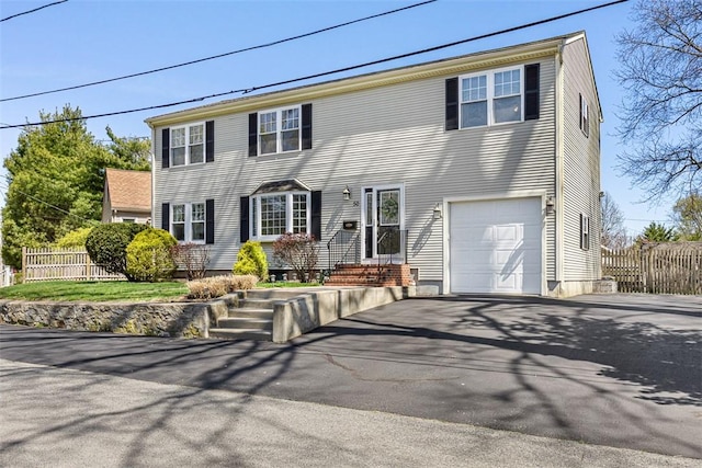 50 Harold St, East Providence, RI 02915 - colonial home with driveway, fence, and an attached garage