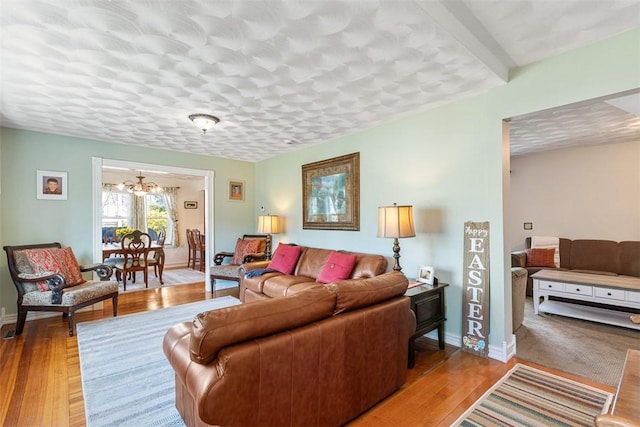50 Harold St, East Providence, RI 02915 - living room featuring a chandelier, light wood finished floors, and baseboards