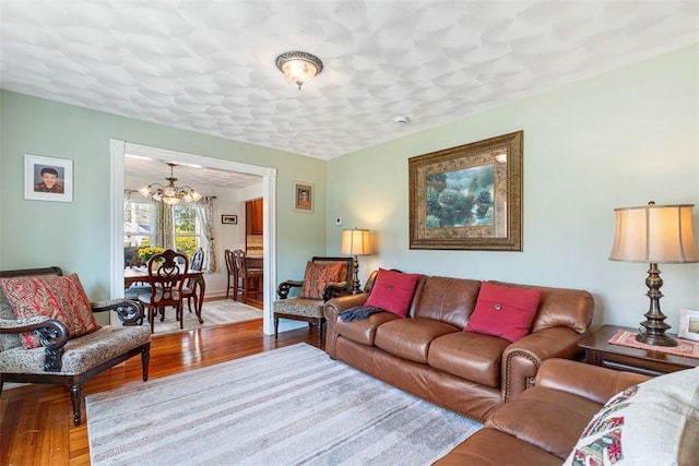 50 Harold St, East Providence, RI 02915 - living room featuring a chandelier, wood finished floors, and baseboards