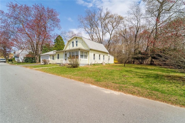dutch colonial with a gambrel roof, a front yard, and an attached garage