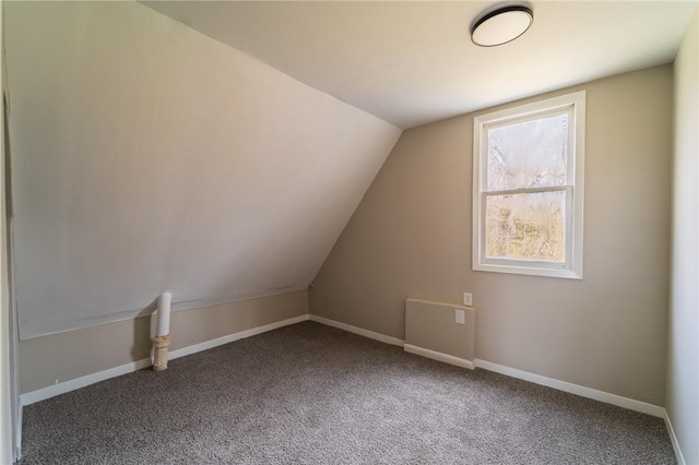 bonus room featuring carpet floors, vaulted ceiling, and baseboards