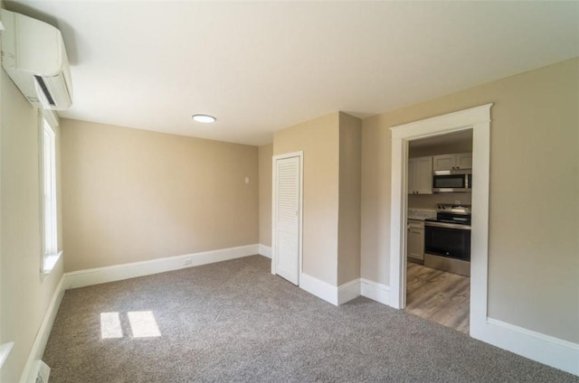 40 Lima St, Warwick, RI 02889 - unfurnished room with light colored carpet, a wall mounted AC, baseboards, and healthy amount of natural light