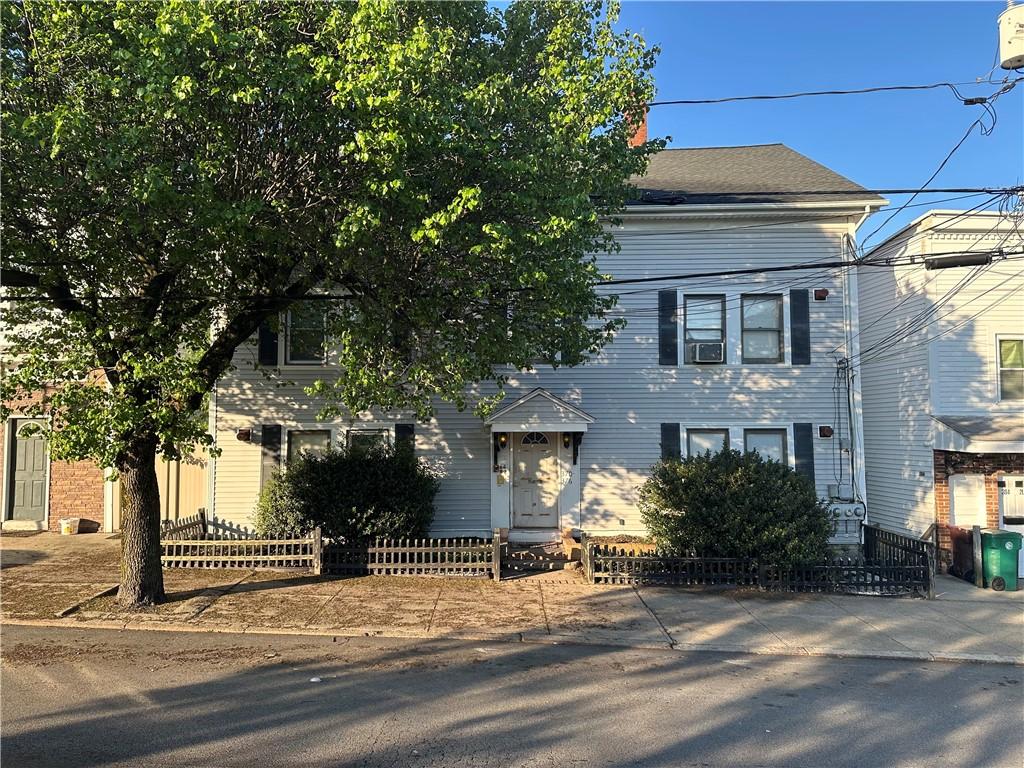 372 River St, Woonsocket, RI 02895 - view of front of property with a fenced front yard