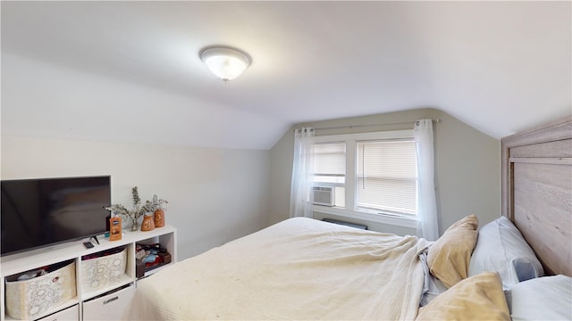 bedroom featuring vaulted ceiling and cooling unit