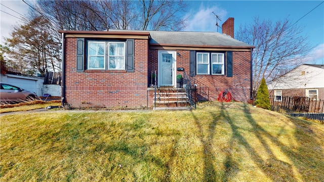 view of front of house featuring brick siding, a chimney, and entry steps