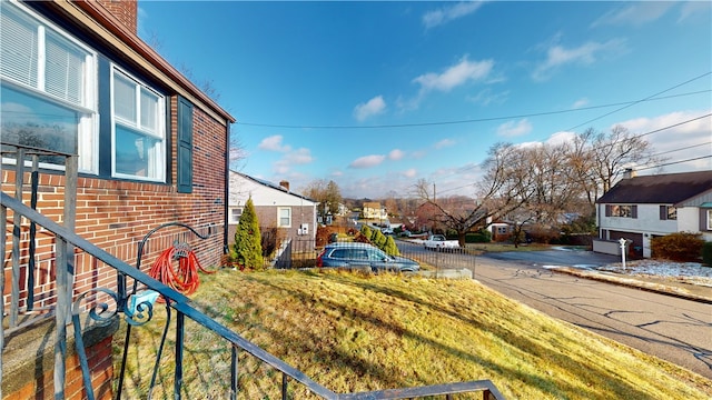 view of yard with a residential view and fence