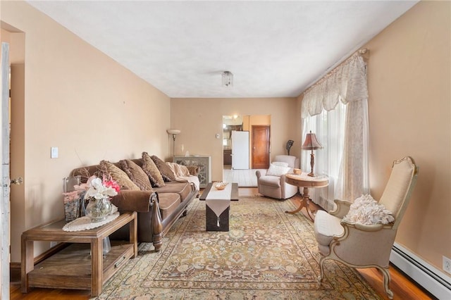 living area featuring baseboard heating and wood finished floors
