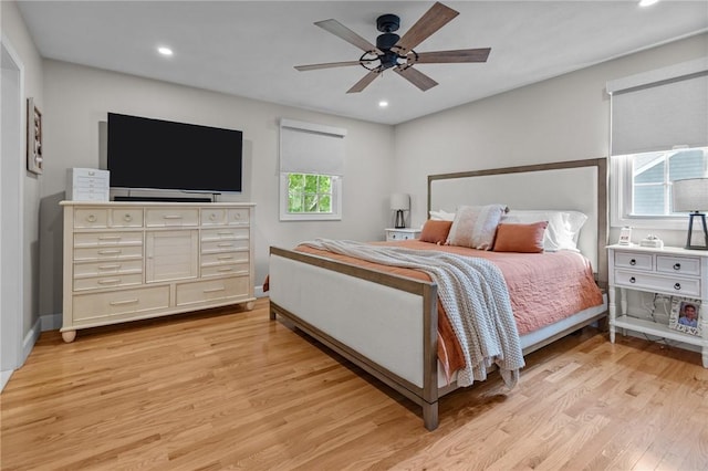 bedroom with light wood-type flooring, recessed lighting, a ceiling fan, and baseboards