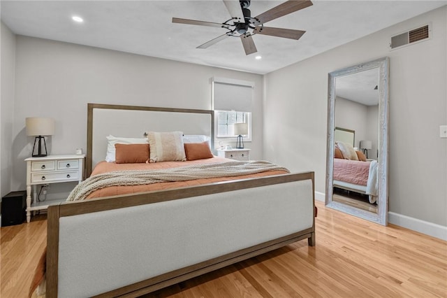 bedroom with light wood-style floors, baseboards, recessed lighting, and a ceiling fan