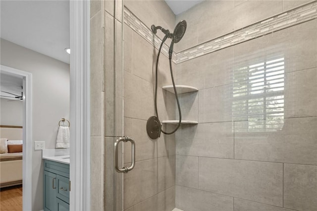 bathroom view of a stall shower, ensuite bathroom, and vanity