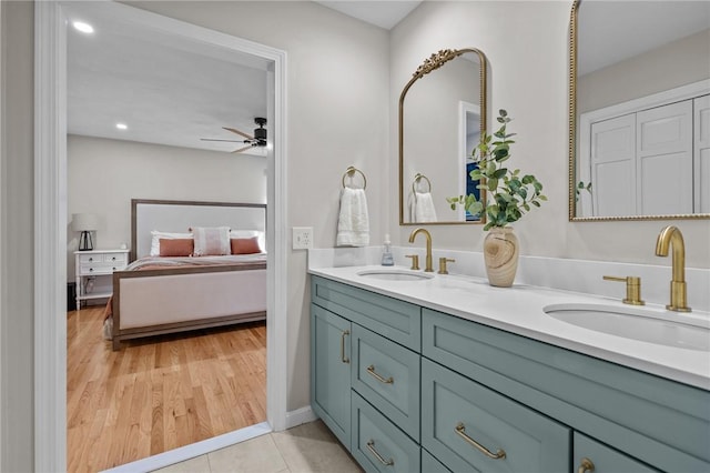 full bath featuring ensuite bathroom, double vanity, ceiling fan, recessed lighting, and wood finished floors