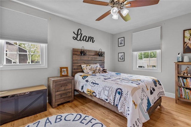 bedroom with light wood-style floors and ceiling fan