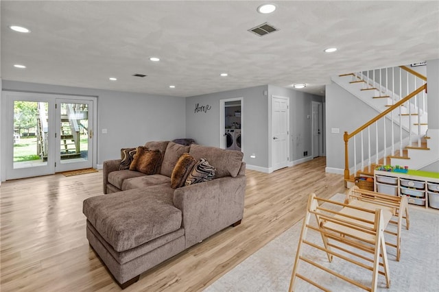living area with independent washer and dryer, light wood-style flooring, recessed lighting, stairway, and baseboards