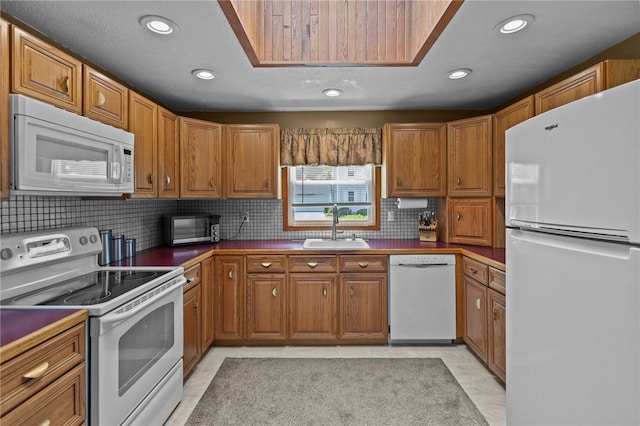 13 Parker Ave, Warren, RI 02885 - kitchen with white appliances, a sink, brown cabinets, recessed lighting, and decorative backsplash