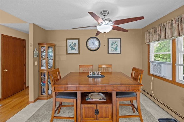13 Parker Ave, Warren, RI 02885 - dining room with a baseboard heating unit, a ceiling fan, cooling unit, and light wood-type flooring