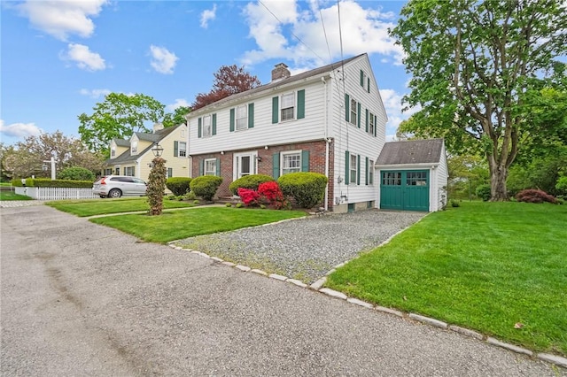 57 Sylvan Rd, East Providence, RI 02916 - colonial inspired home featuring a chimney, brick siding, a front yard, a garage, and gravel driveway