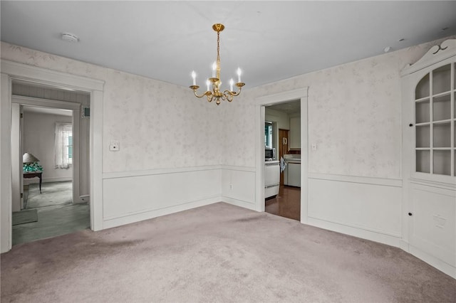 57 Sylvan Rd, East Providence, RI 02916 - unfurnished dining area with carpet flooring, a chandelier, wainscoting, and wallpapered walls