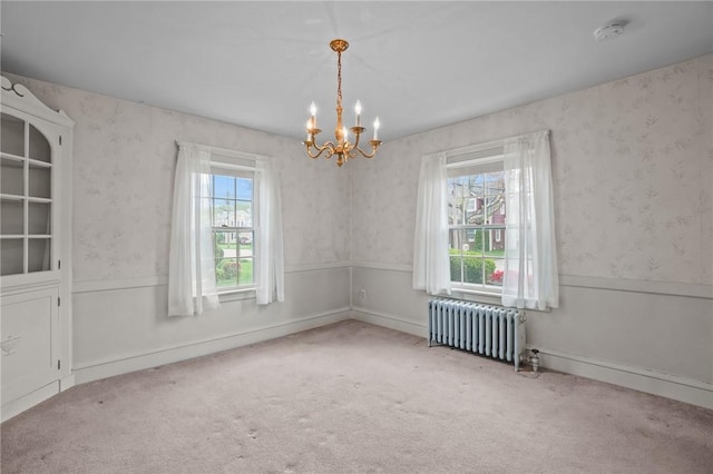 57 Sylvan Rd, East Providence, RI 02916 - spare room with radiator heating unit, a chandelier, a smoke detector, carpet floors, and a wainscoted wall