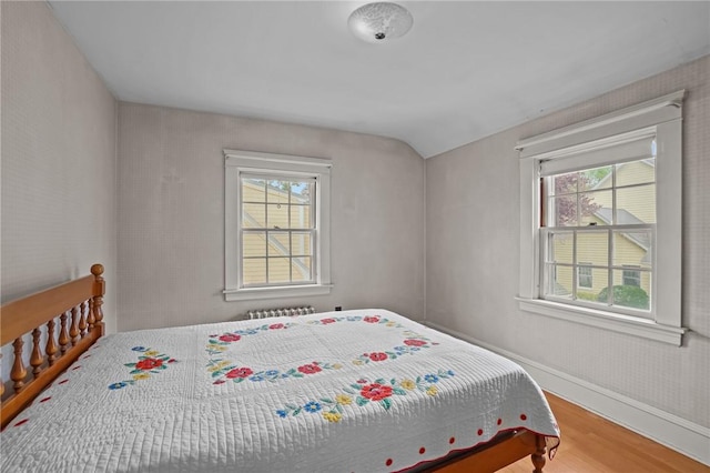 57 Sylvan Rd, East Providence, RI 02916 - bedroom with wood finished floors, multiple windows, vaulted ceiling, and baseboards