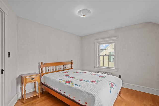 57 Sylvan Rd, East Providence, RI 02916 - bedroom featuring light wood finished floors, baseboards, radiator, and lofted ceiling
