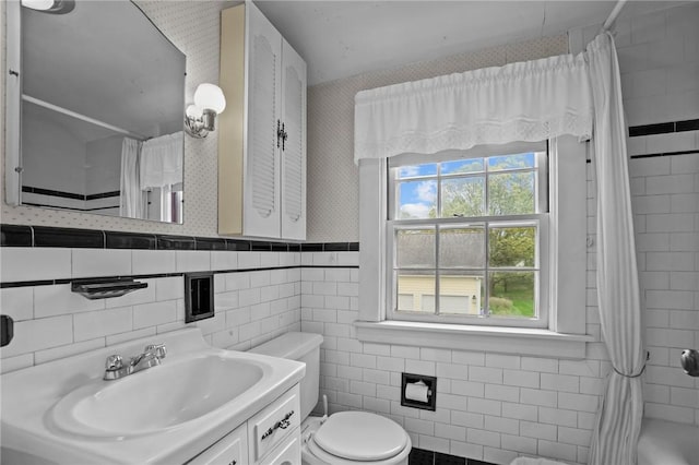 57 Sylvan Rd, East Providence, RI 02916 - bathroom with toilet, tile walls, curtained shower, wallpapered walls, and vanity