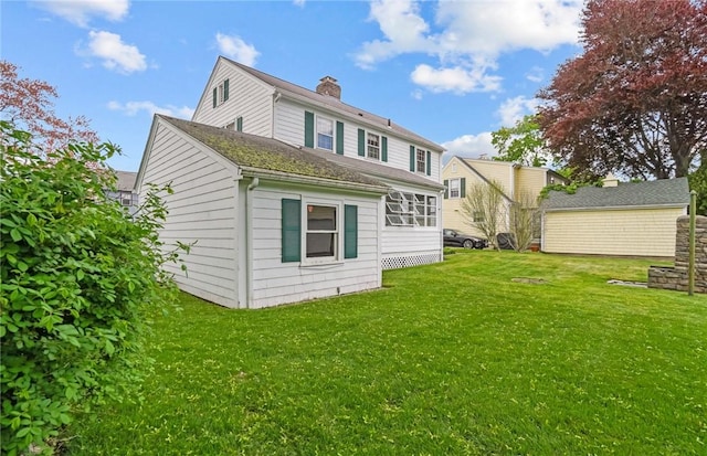 57 Sylvan Rd, East Providence, RI 02916 - rear view of property featuring a lawn and a chimney