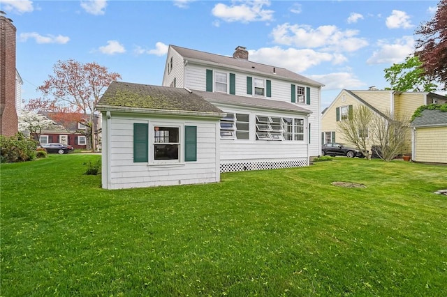 57 Sylvan Rd, East Providence, RI 02916 - rear view of house featuring a chimney, a lawn, and roof with shingles