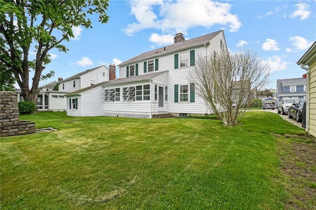 57 Sylvan Rd, East Providence, RI 02916 - back of property with a chimney, a lawn, and entry steps